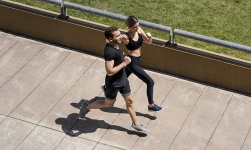 high-angle-man-woman-jogging-together-outdoors